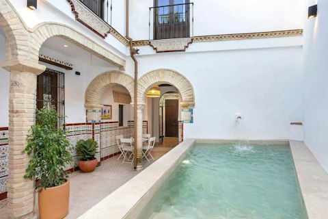 Cool off in the courtyard pool beneath traditional arches