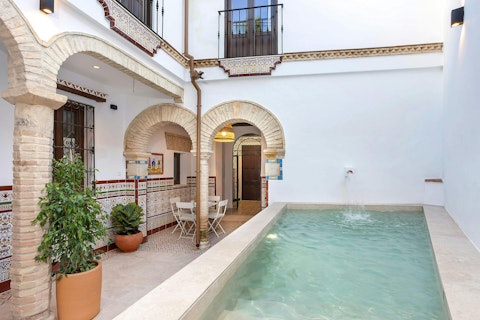 Cool off in the courtyard pool beneath traditional arches