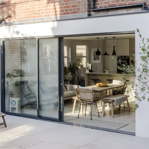 Slide open the wall of glass and blend indoors with outdoors