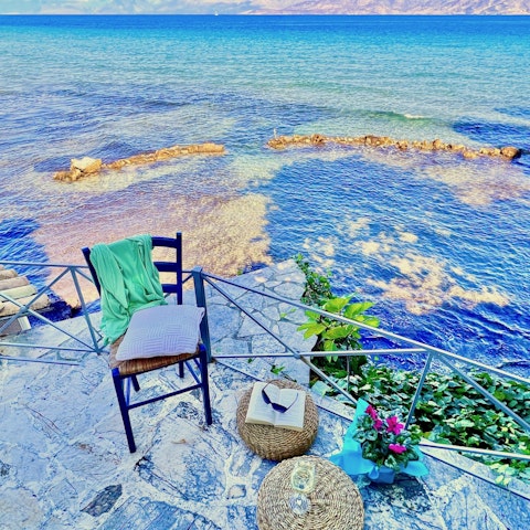 Spend afternoons reading as the waves lap the shore below