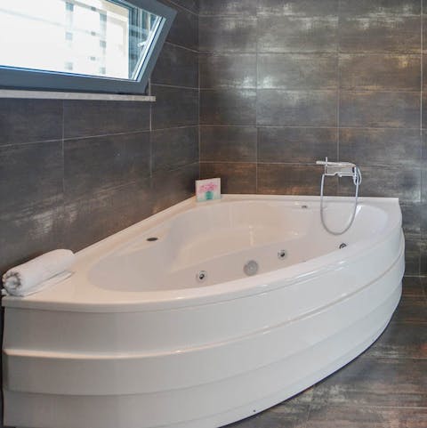 Sink into the corner Jacuzzi bath, a glass of bubbly in hand