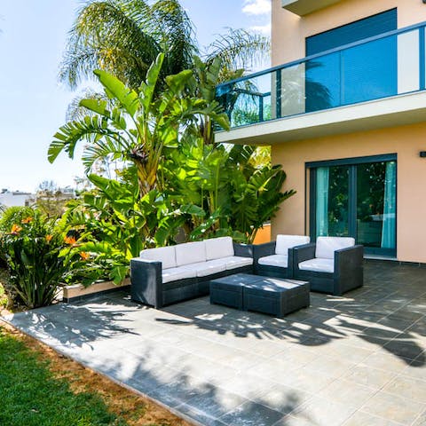 Gather together for shaded drinks on the outdoor sofa