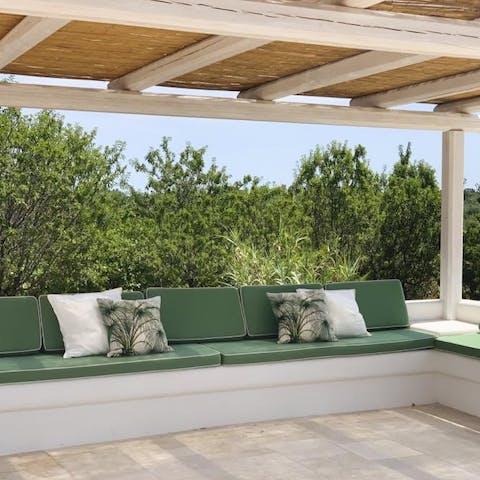 Laze on the L-shaped seating area on the covered poolside terrace