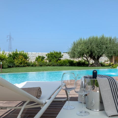 Jump into the home's swimming pool and dry off on one of the loungers