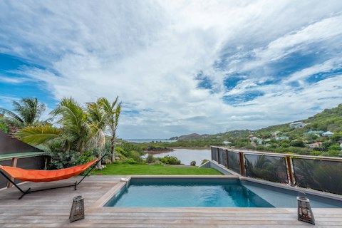 Swim above the lagoon with the island hills beyond