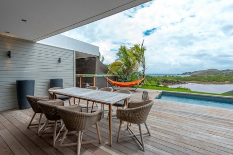 Host long lunches overlooking the bay and pool