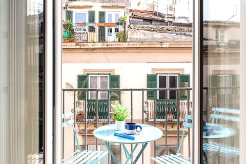 Sip your morning coffee above Palermo's sun-warmed rooftops