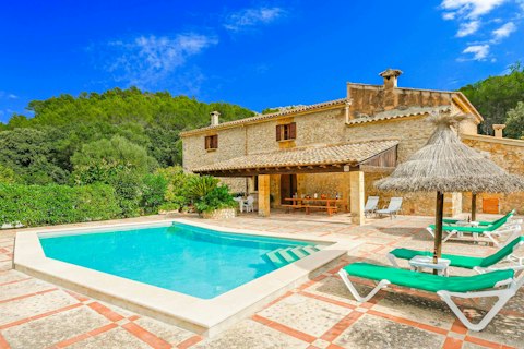 Swim in the pool backed by wooded hills and warm stone