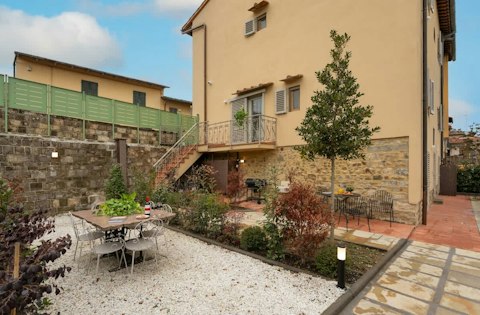 Dine alfresco among stone walls and garden planting