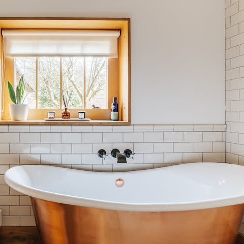 Enjoy a long soak in the luxurious roll top bathtub