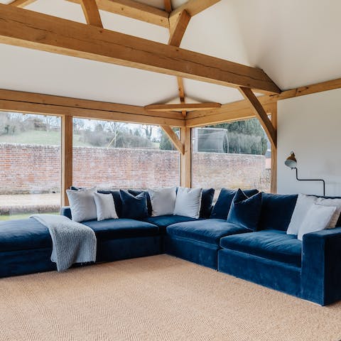 Get cosy for evenings on the home's oversize velvet sofas