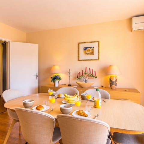 Gather around the mid-century style dining table for relaxed dinners and drinks at home