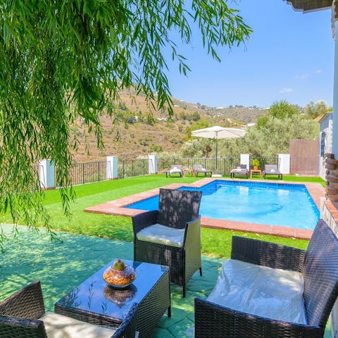 Seek out a shaded spot by the pool and get into a good book