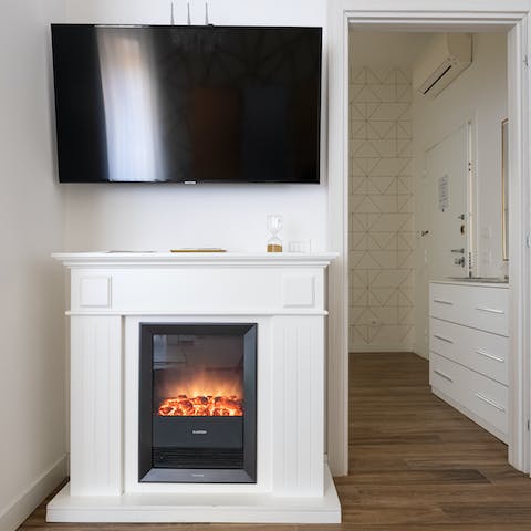 Spend cosy evenings in bed with the fire for atmosphere and warmth