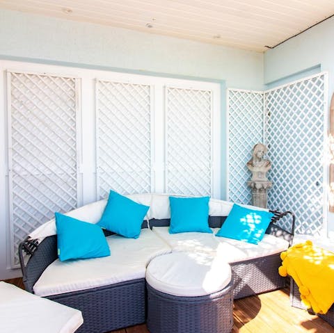 Cosy up with some cocktails on the outdoor sofa
