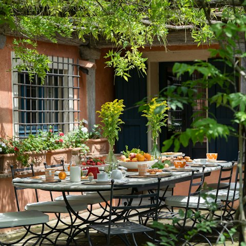 Dine alfresco, under the wisteria-covered pergola