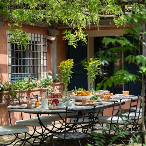 Dine alfresco, under the wisteria-covered pergola
