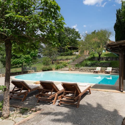 Drink in the Tuscan sun from beside the private pool