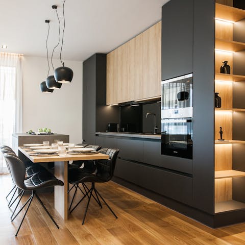 Prepare firm family favourites in the chic kitchen before dining beneath pendant lights in the living area