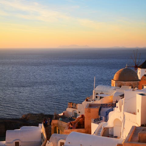 Watch the sunset over Oia's iconic rooftops