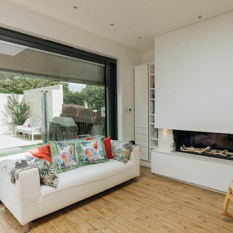 Cosy up by the modern fireplace after a busy day of walking