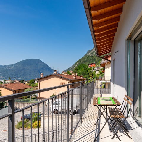 Admire the beautiful views of the lake and the mountains from the balcony