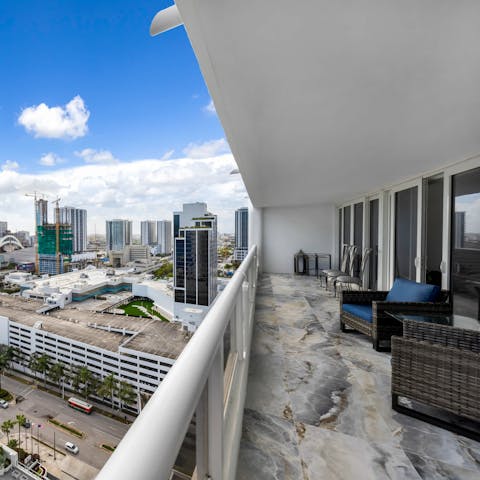 Relax on the spacious balcony, overlooking the city skyline