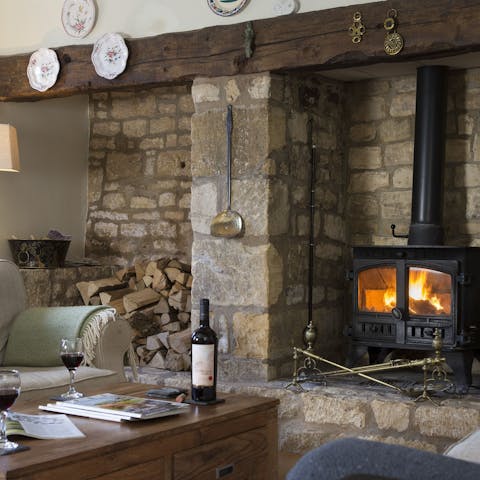 Relax by the log burning fireplace with a glass of wine after a country walk