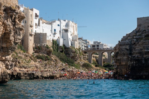 Drive to Polignano a Mare's clifftop old town above turquoise Adriatic coves