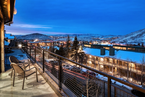 Watch the town lights flicker against the snow-covered mountains