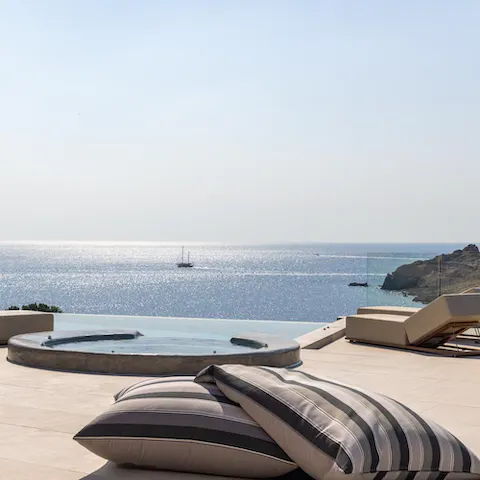 Admire the sparkling Aegean Sea from the luxurious private Jacuzzi