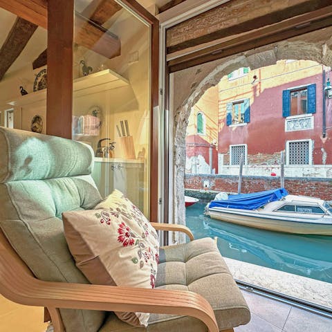 Watch the gondolas glide past from the chair in the window