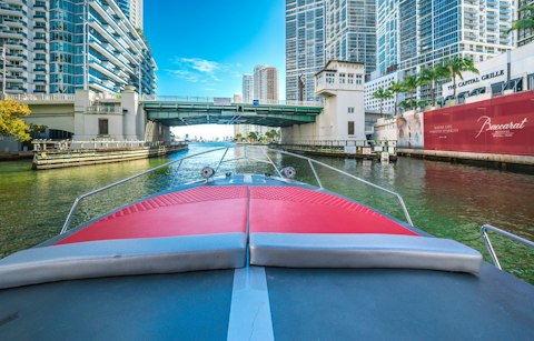 Explore the historic Miami River's lively waterfront dining and boat traffic