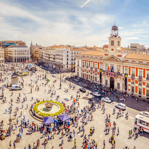 Visit bustling Puerta del Sol, an eight-minute stroll from your door