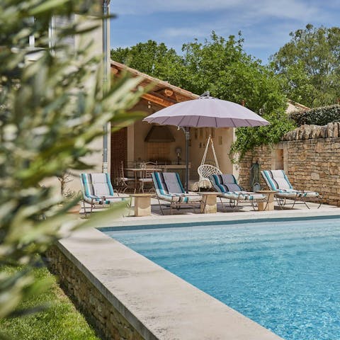 Relax on a poolside sun lounger with a book