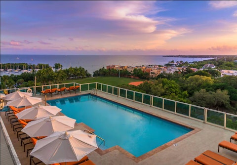 Watch the sunset from a lounger by the shared pool