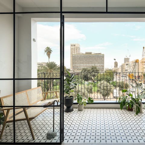Spend time on the pretty mosaic balcony overlooking Rabin Square