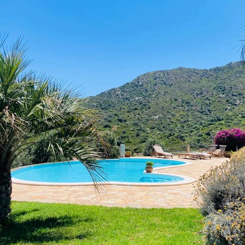 Soak in the mountain and distant sea views from the pool