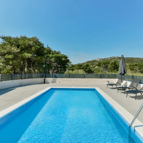 Chill by the private pool, overlooking the mountains