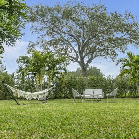 Relax in the palm tree-lined garden