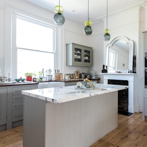 Prepare a home-cooked meal at the large marble island