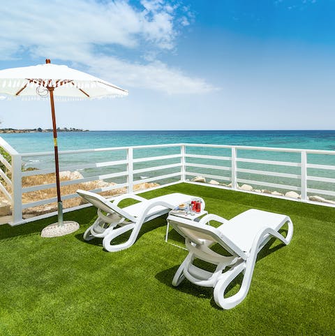 Stretch out on a sun lounger with a good book and a cool drink