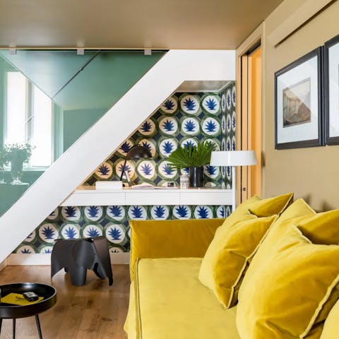 Get cosy on the mustard yellow sofa after a long day in Rome