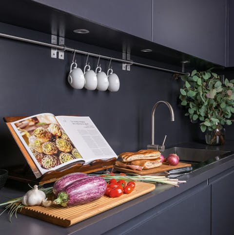 Whip up a light bite in the moody-hued kitchen