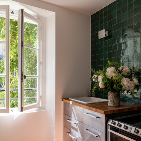 Prepare a meal in the sunny kitchen using produce from the local shops