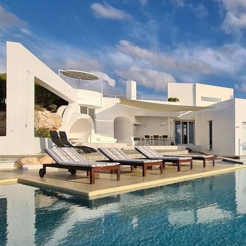 Soak up delicious Grecian rays from comfortable sun loungers