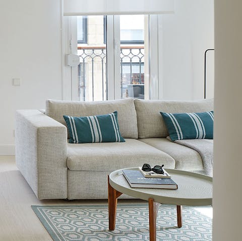 Unwind on the sofa after a long day at La Concha, a glass of Spanish wine in hand
