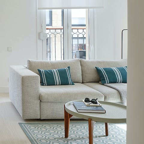 Unwind on the sofa after a long day at La Concha, a glass of Spanish wine in hand