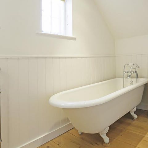 Enjoy a long soak in the luxurious roll tub bath after a day out and about