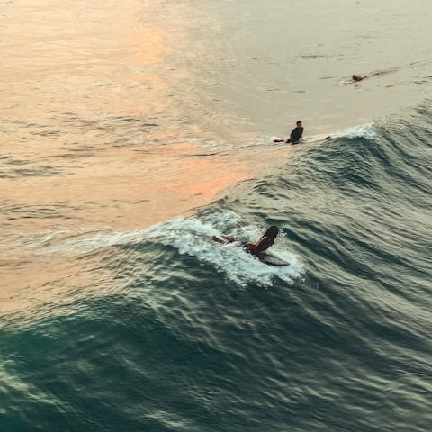 Wake up early and go surfing on Canggu beach, it's a fifteen-minute drive